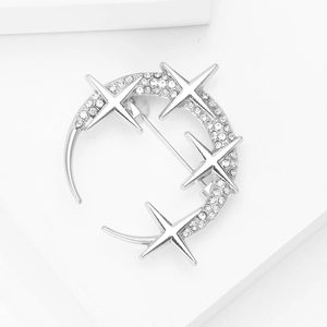Close-up of crescent moon and stars brooch with sparkling rhinestones in silver finish