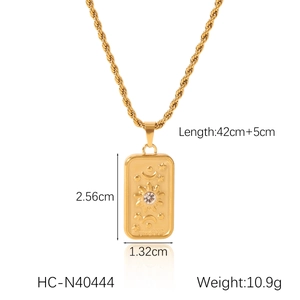 Detail view of The Sun tarot pendant showing dimensions 2.56cm x 1.32cm on a gold twist chain