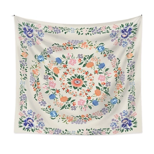 Detail of a mandala tapestry with intricate colorful floral patterns and rose motifs on cream fabric