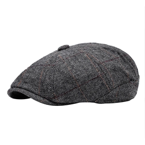 Classic grey herringbone newsboy cap with wool blend and subtle orange plaid pattern