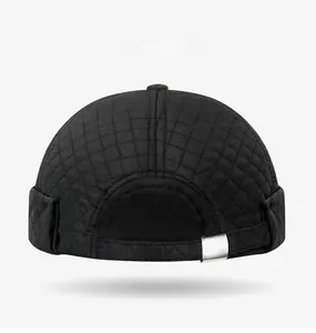 Rear view of black quilted docker cap with diamond texture and adjustable metal buckle