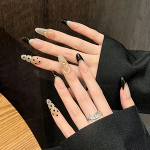 Handmade black cat eye press-on nails with French tips and gold glitter accents