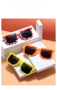 Macro detail of pixel mosaic sunglasses in red, orange, and yellow on white blocks
