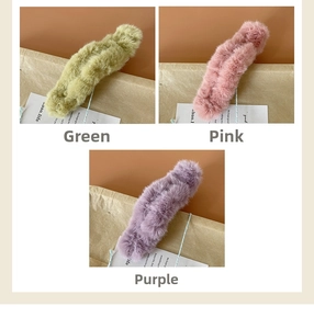 Detailed view of green pink and purple plush claw clips with soft faux fur texture