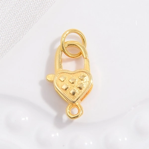 Macro view of gold-plated S925 silver heart lobster clasp with star emboss for jewelry