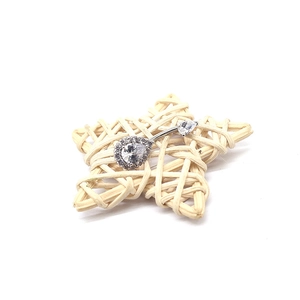 Makroaufnahme von silbernem Tropfen-Bauchnabelpiercing mit klarem Zirkonia auf Stern