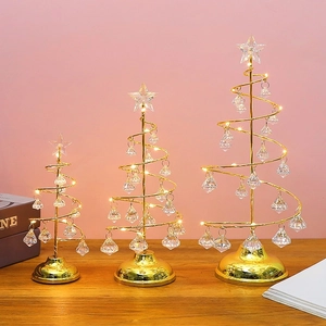 Three sizes of glowing crystal Christmas trees with golden metal frames and LED stars