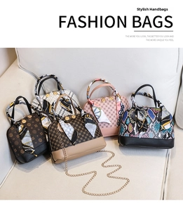 Detail of five shell-shaped mini handbags with silk scarves and gold chain straps