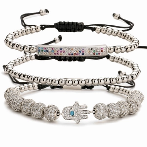 Three-piece silver bead and woven bracelet set featuring a colorful Hamsa hand charm