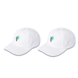 Detail of two white cotton baseball caps featuring green palm tree embroidery on front