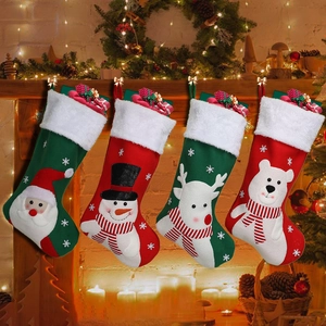 Set of 4 Christmas stockings featuring Santa, snowman and reindeer on festive fireplace