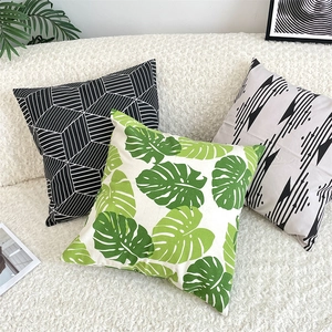 Detailed view of three Nordic cotton linen cushion covers with leaf and geometric patterns