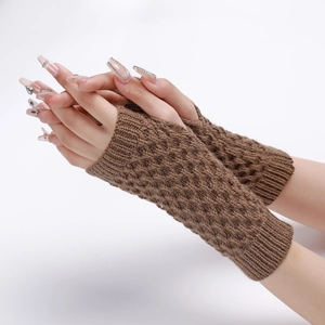 Detailed knit texture of brown pineapple pattern fingerless gloves on a model