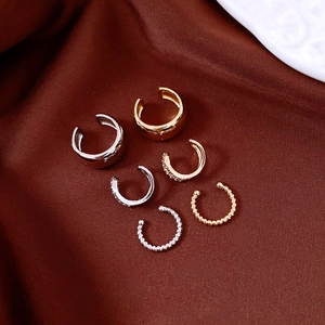 Close-up of 18k gold and silver plated non-pierced ear cuff set with zircon details