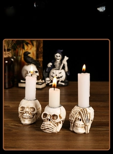 Detailed view of three resin skull candle holders with realistic bone texture for Halloween