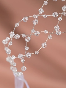 Macro detail of handmade silver mesh headband with sparkling clear faceted crystal beads