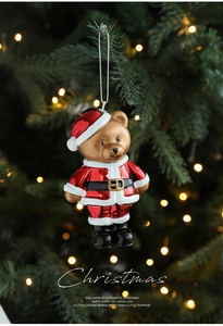 Detailed view of Santa bear ornament with red glitter finish hanging on a Christmas tree