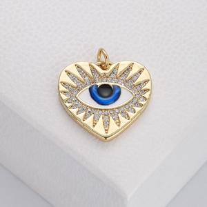 Detailed close-up of heart-shaped evil eye pendant with blue center and white crystals