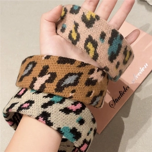 Three-piece leopard print plush headbands in beige, brown, and pink knitted fabric