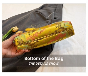 Close-up of yellow silk brocade bag bottom with floral patterns and silk tassel