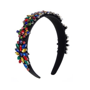 Detailed macro view of handcrafted multi-color rhinestones set on a black fabric headband