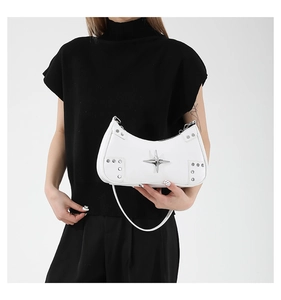Detail of white PU leather crescent bag with silver star and rivets on black attire