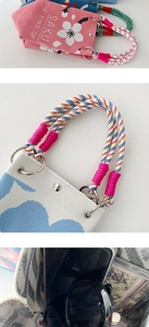 Detail of knitted tote bag showing woven rope handles and interior storage capacity