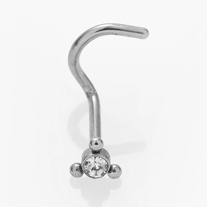 Close-up of silver stainless steel nose stud with curved bar and clear zircon skull