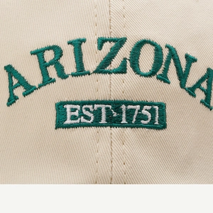 Detailed macro shot of ARIZONA embroidery on beige cotton twill baseball cap