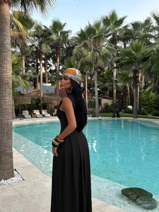 Elegant black sleeveless evening dress with open shoulder design and side view detail