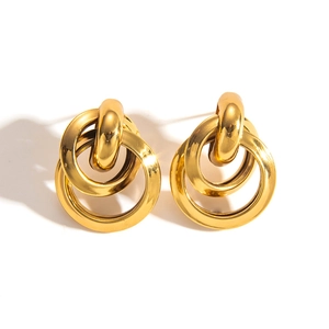 Detailed close-up of triple interlocking gold hoop earrings in polished titanium steel