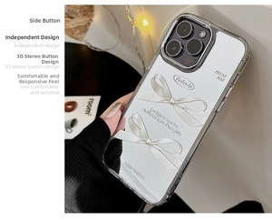 Close-up of iPhone case with 3D pearl bows and decorative French typography