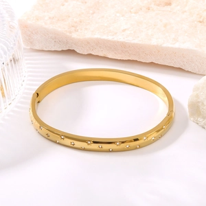 Minimalist 18K gold plated stainless steel bangle with engraved stars and zircon stones