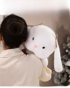 Close-up of a large white plush rabbit toy showing its soft texture and heart-shaped nose