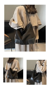 Detail of black suede tote bag featuring white contrast stitching and geometric leather patch