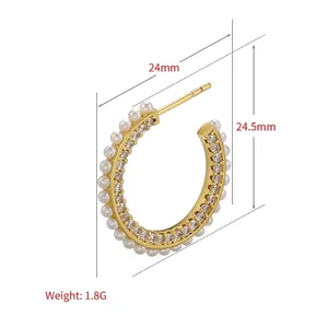 Gold C-shaped hoop earrings with pearls and micro-pave cubic zirconia stones