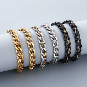 Detail of double-layer Cuban link bracelets in gold, silver, and black stainless steel