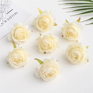 Set of 8 cream white artificial silk rose heads for wedding decorations on white surface