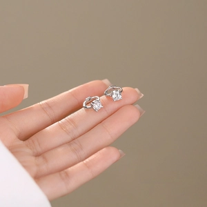 Elegant S925 sterling silver hoop earrings with sparkling cubic zirconia on a hand