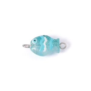 Close-up of a blue glass fish bead with white wave patterns and silver metal rings