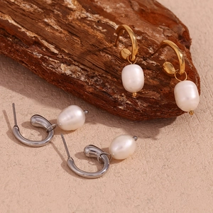 Detailed shot of gold and silver stainless steel hoop earrings with freshwater pearls