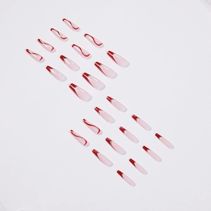 French tip cherry red press-on nails with wave patterns and silver glitter detail