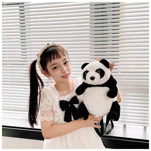 Close-up of a large plush panda shoulder bag held by a girl in natural bright light