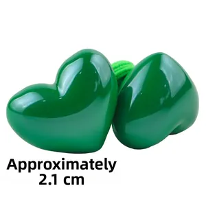 Detail of green heart-shaped hair ties with high-gloss resin finish and 2.1cm diameter