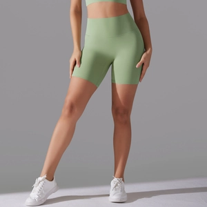 Detail of high-waist light green yoga shorts with a seamless fit on an athletic model