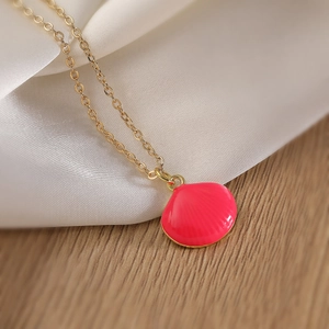 Pink shell pendant necklace with 18K gold plating on elegant white silk fabric
