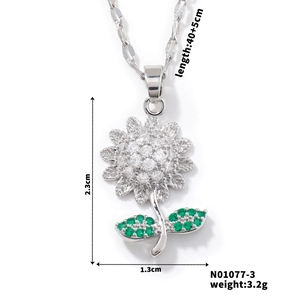 Macro view of sunflower pendant with white and green zircons including dimensions