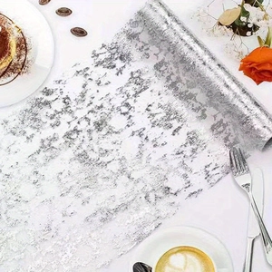 Silver metallic foil roll for table decoration shown in a high-end dessert cafe setting