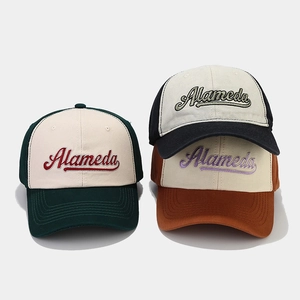 Detailed view of Alameda cursive embroidery on multi-color contrast baseball caps