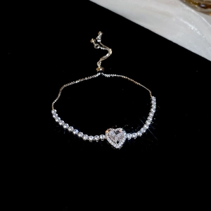 Detail of adjustable silver heart bracelet with sparkling cubic zirconia stones